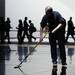 A crew member sweeps the floor before the start of the Mercedes-Benz press presentation at the North American International Auto Show during the press preview on Monday, Jan. 14, at Cobo Center in Detroit.   Melanie Maxwell I AnnArbor.com 